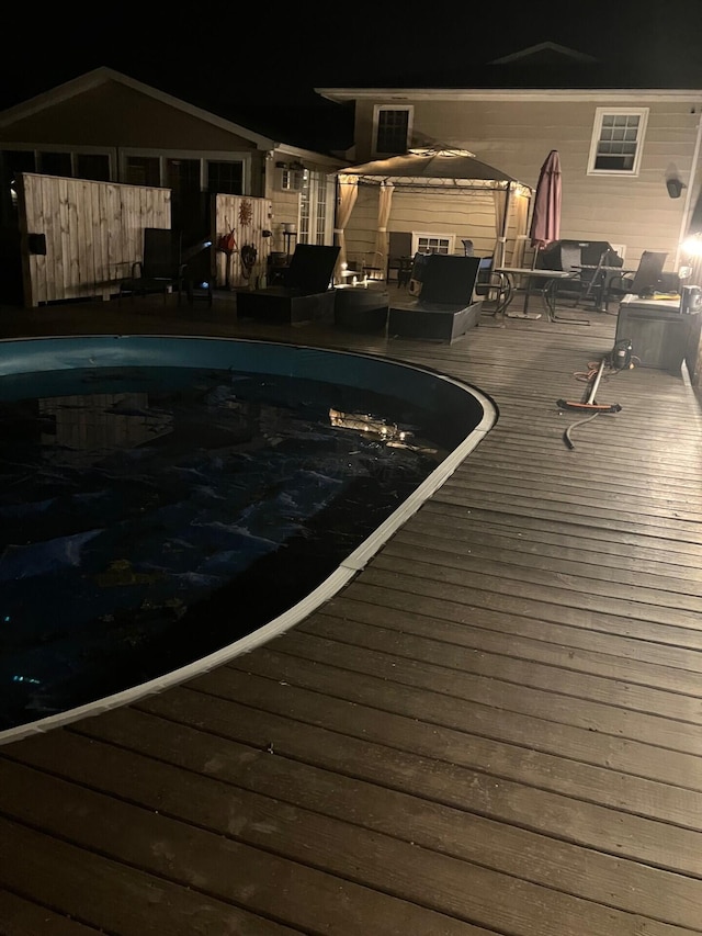 pool at night with a deck