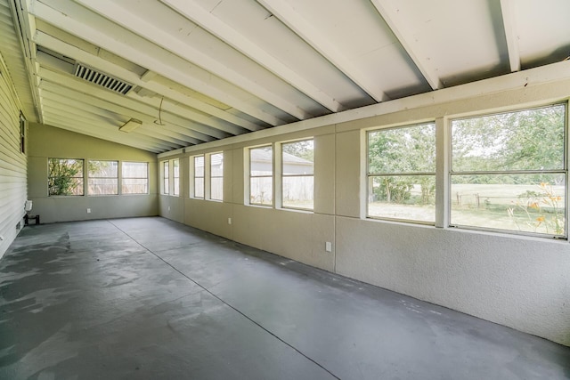 unfurnished sunroom featuring vaulted ceiling