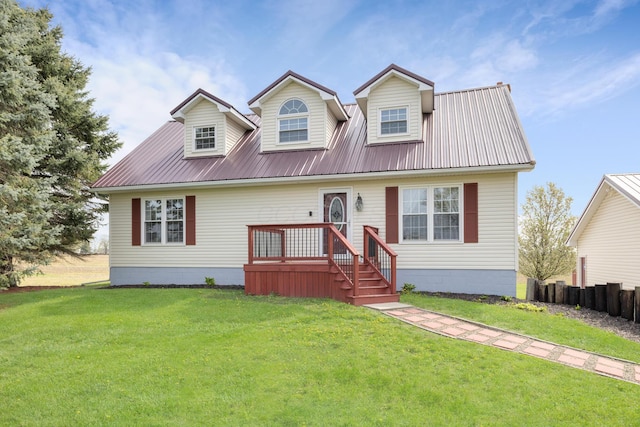 cape cod house featuring fence, metal roof, and a front lawn