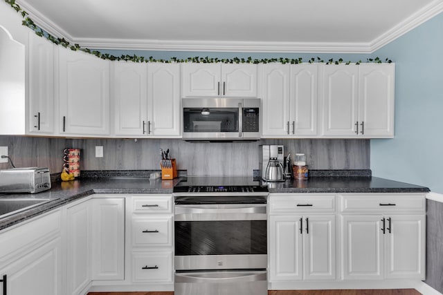kitchen featuring stainless steel appliances, decorative backsplash, crown molding, dark countertops, and white cabinets