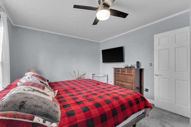 carpeted bedroom with baseboards, ceiling fan, and crown molding