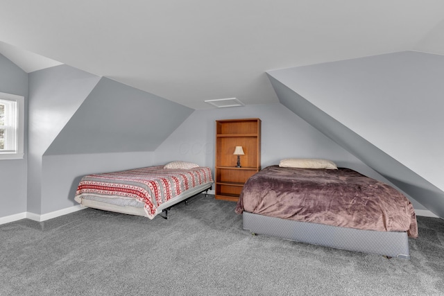 carpeted bedroom with lofted ceiling and baseboards