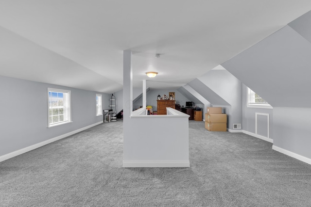 bonus room with carpet, a healthy amount of sunlight, and vaulted ceiling