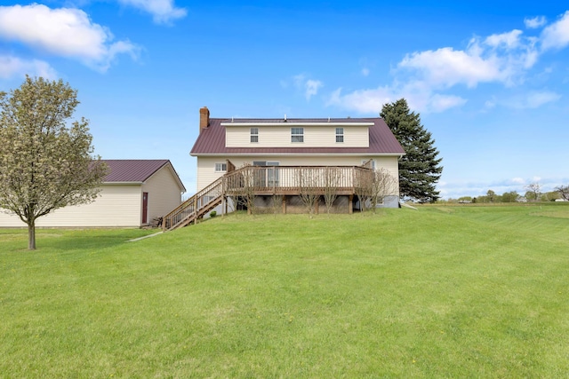 back of house featuring a lawn, stairway, a chimney, and a wooden deck