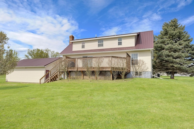 back of house featuring stairway, a yard, a wooden deck, and metal roof