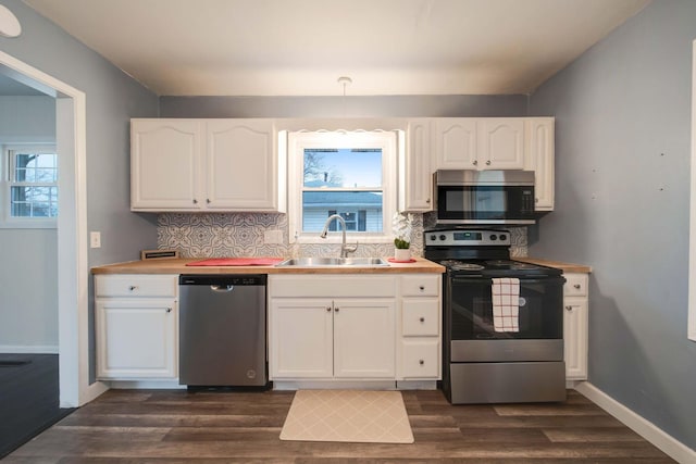 kitchen featuring white cabinetry, plenty of natural light, stainless steel appliances, and sink