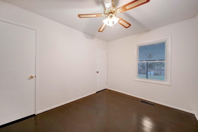 unfurnished room featuring dark hardwood / wood-style floors and ceiling fan