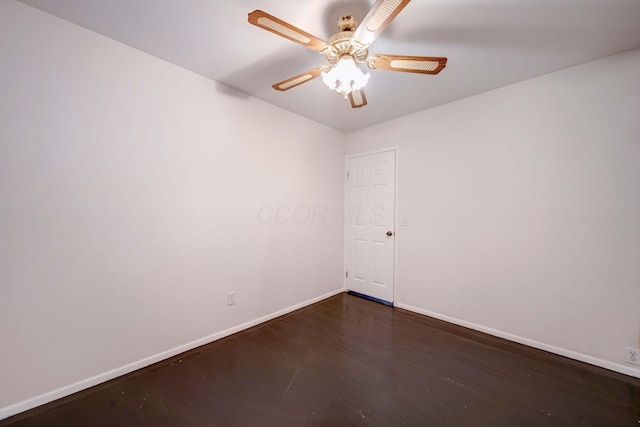 empty room with ceiling fan and dark hardwood / wood-style flooring