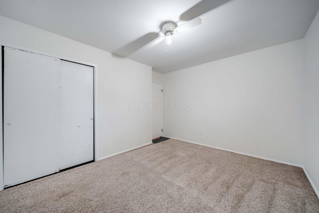 unfurnished bedroom with carpet flooring, ceiling fan, and a closet