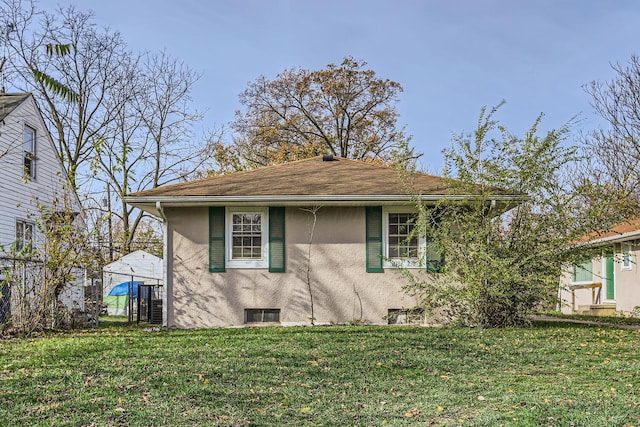 view of side of home with a lawn