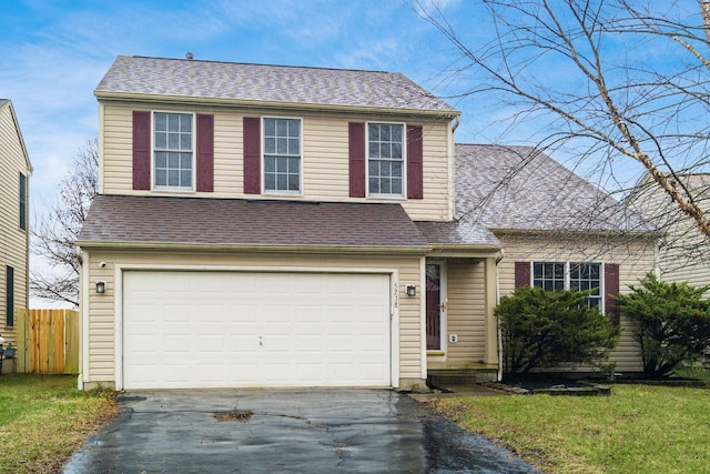 view of front of property with a front lawn and a garage