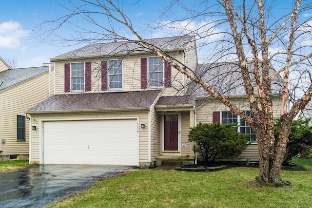 view of front of house featuring a garage and a front lawn