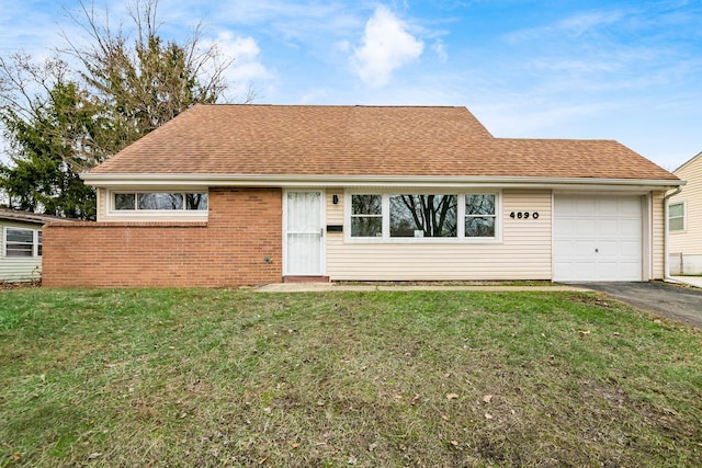 ranch-style house with a garage and a front lawn