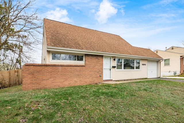 view of front of home with a front yard and a garage