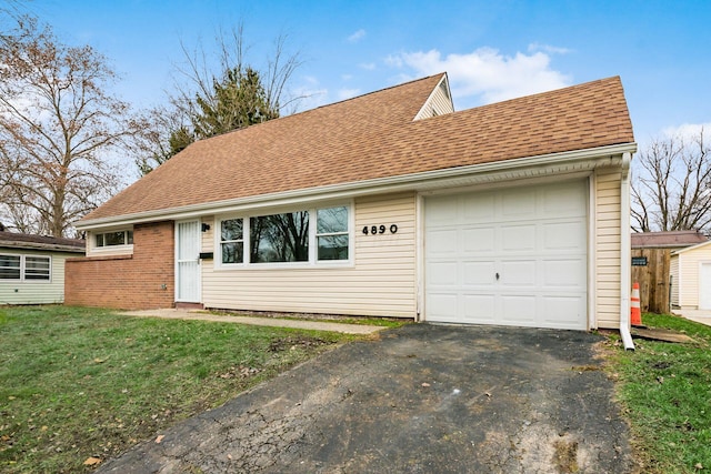 view of front facade with a front yard and a garage