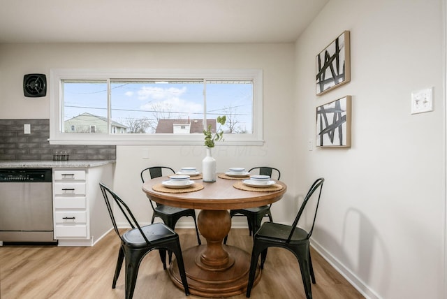 dining space featuring a healthy amount of sunlight and light hardwood / wood-style flooring