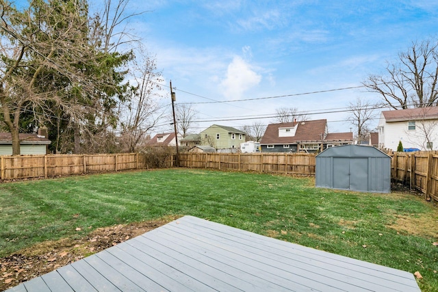 view of yard with a shed and a wooden deck