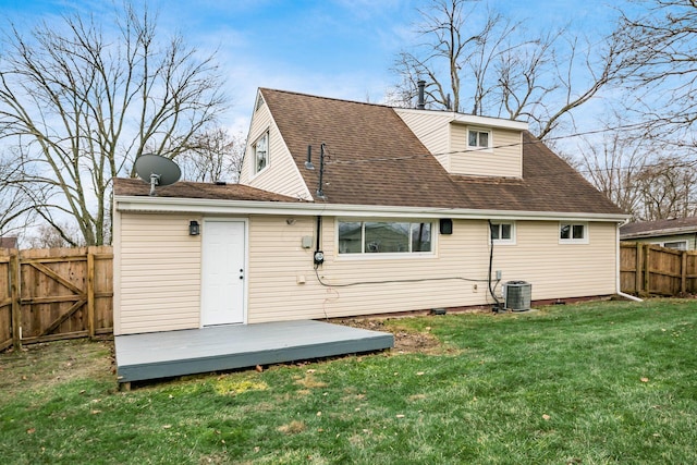 rear view of house featuring a lawn and a wooden deck