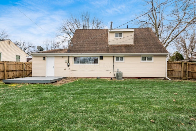 back of house featuring a wooden deck, a yard, and central AC