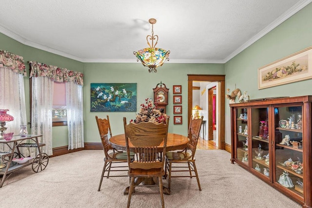 carpeted dining room featuring a textured ceiling and ornamental molding