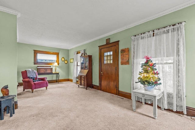 sitting room featuring carpet and ornamental molding