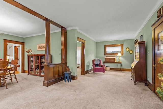 sitting room featuring decorative columns, crown molding, and light colored carpet