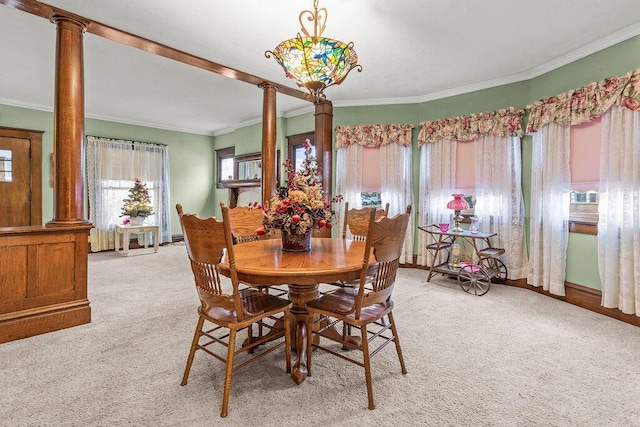 dining space with light colored carpet, ornate columns, and ornamental molding