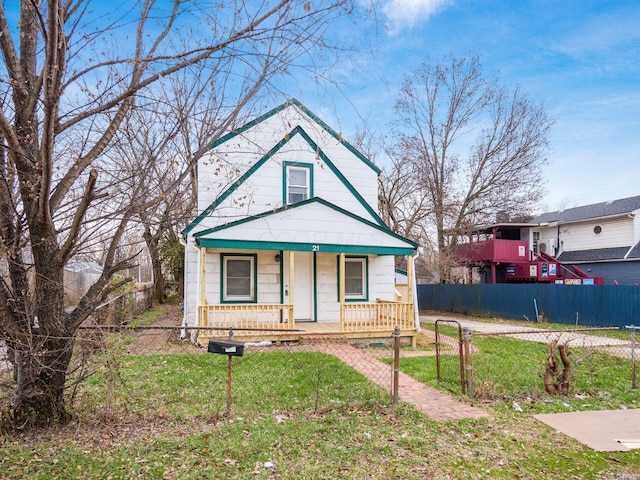 bungalow-style house featuring covered porch and a front yard