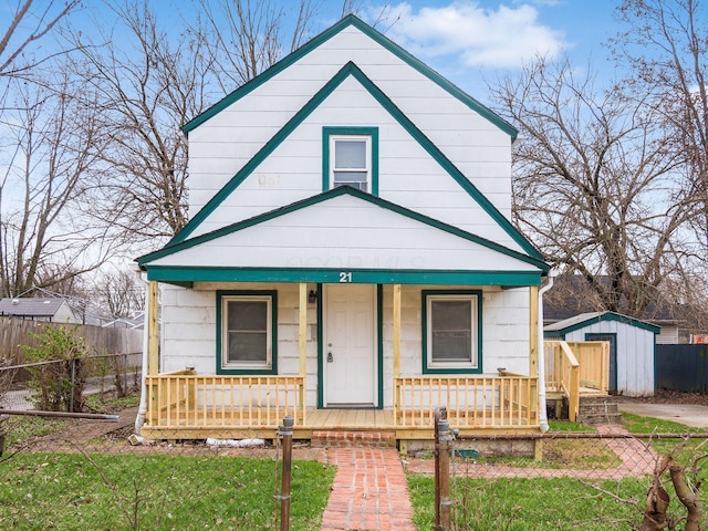 bungalow-style home featuring a shed and a porch