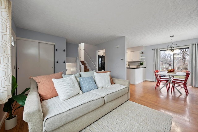 living room featuring a textured ceiling and light hardwood / wood-style flooring