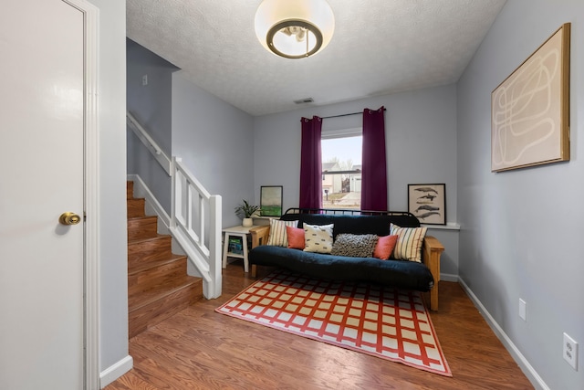 sitting room with a textured ceiling and hardwood / wood-style flooring