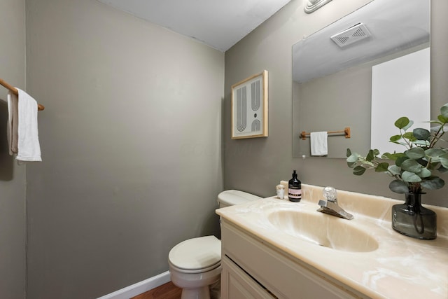 bathroom featuring toilet and vanity