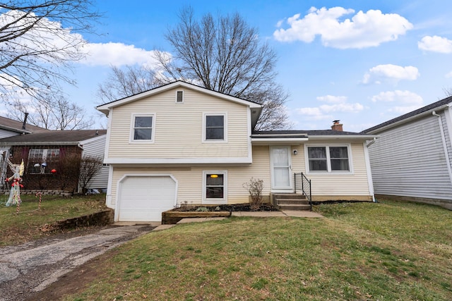 split level home with a front yard and a garage