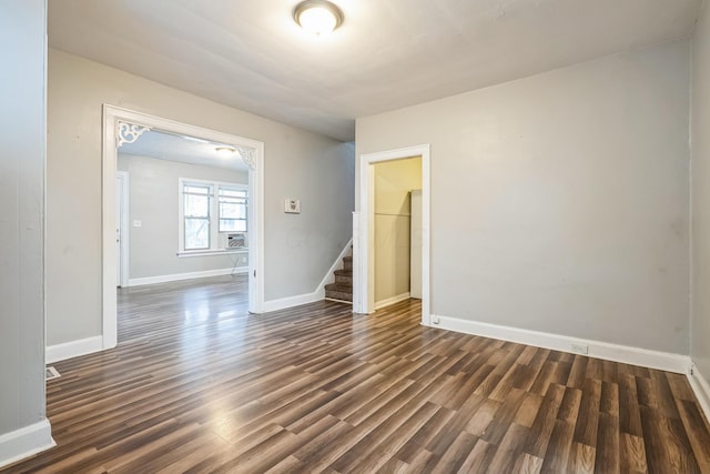 spare room featuring dark wood-type flooring