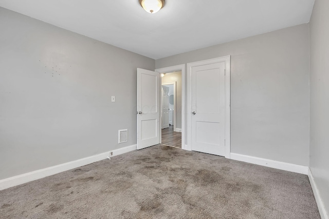 unfurnished bedroom featuring dark colored carpet