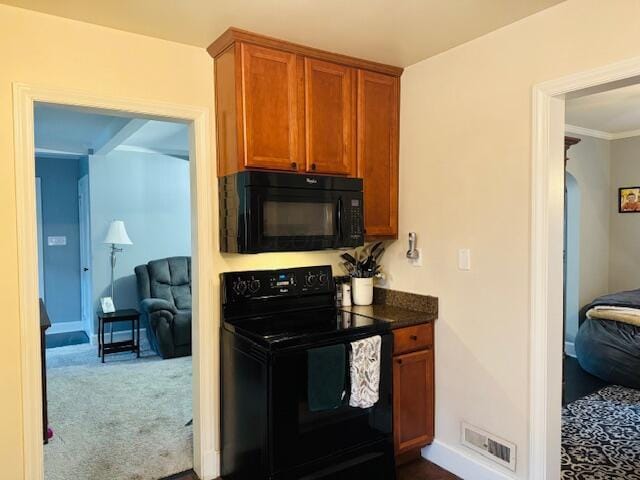 kitchen with carpet flooring and black appliances