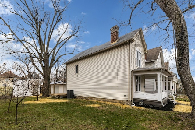 view of home's exterior featuring a yard and central AC