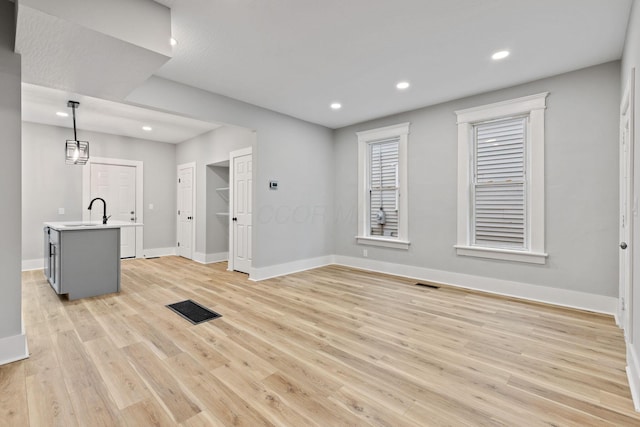 interior space with light wood-type flooring and sink