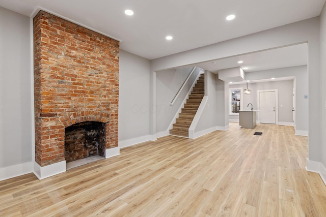 unfurnished living room featuring light hardwood / wood-style floors and a fireplace