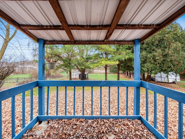 wooden deck with a storage shed