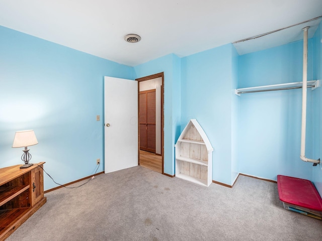 bedroom with light colored carpet and a closet