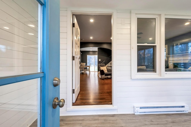 doorway to property featuring baseboard heating