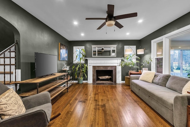 living room with hardwood / wood-style floors, plenty of natural light, and a tile fireplace