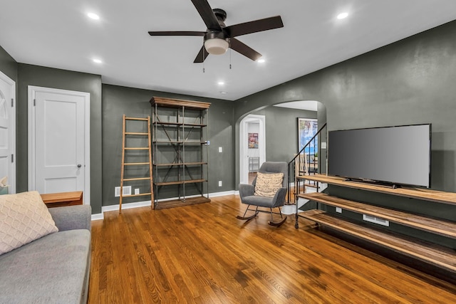 living area featuring hardwood / wood-style floors and ceiling fan