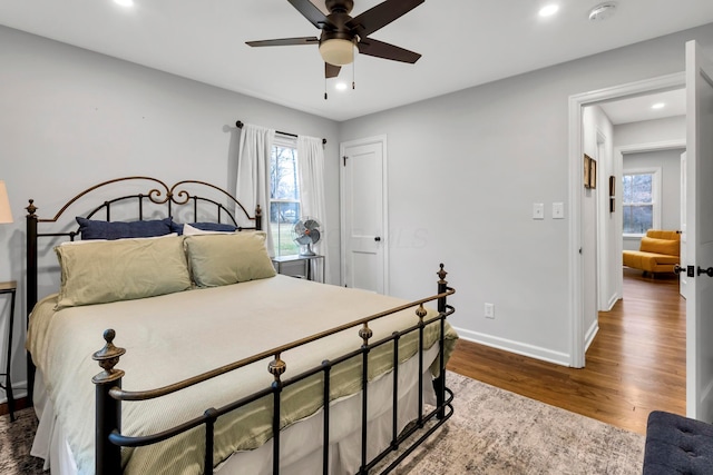 bedroom with ceiling fan and hardwood / wood-style floors