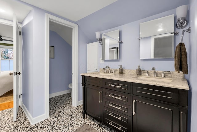 bathroom with tile patterned flooring, vanity, and toilet