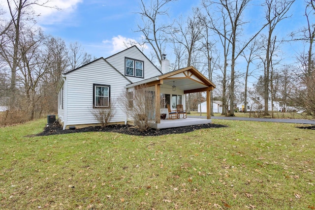 exterior space featuring central AC, ceiling fan, and a front lawn