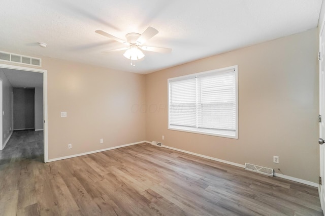 spare room featuring ceiling fan and wood-type flooring