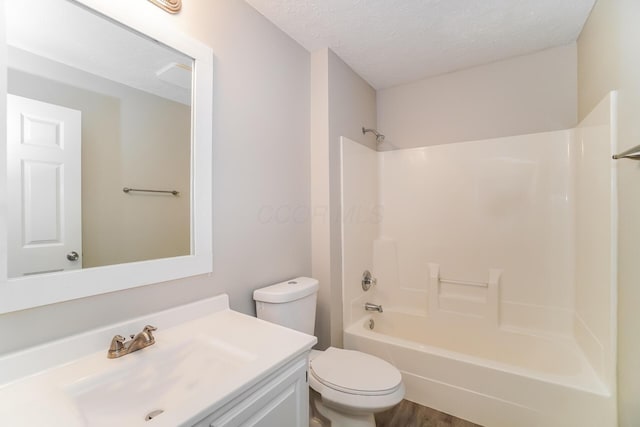 full bathroom with vanity, a textured ceiling, shower / tub combination, wood-type flooring, and toilet