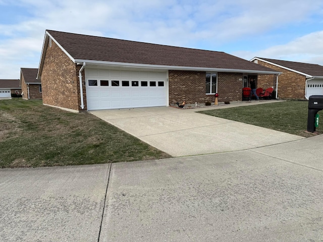 ranch-style house featuring a front yard and a garage